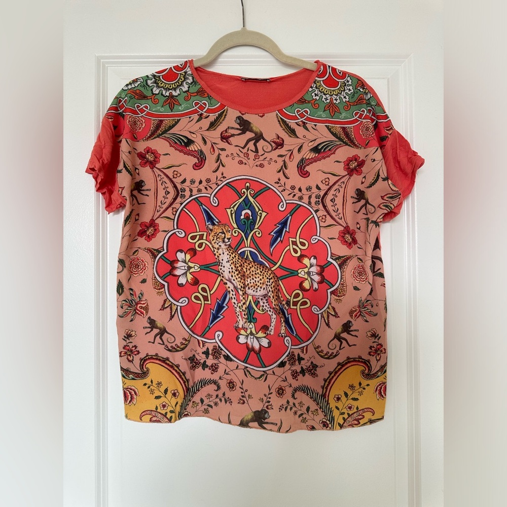 Orange mixed media geometric and animal figures top
